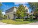 Charming two-story home showcasing a well-manicured lawn, mature trees, and inviting curb appeal at 8256 Bayview Crossing Dr, Winter Garden, FL 34787