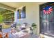 Welcoming front porch features comfortable seating, stylish decor, and a charming entrance at 8256 Bayview Crossing Dr, Winter Garden, FL 34787
