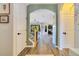 Inviting hallway with hardwood flooring and natural light, leading to open living areas and the staircase at 8256 Bayview Crossing Dr, Winter Garden, FL 34787