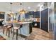 Chic kitchen features granite island with seating, stainless steel appliances, and ample cabinet space at 8256 Bayview Crossing Dr, Winter Garden, FL 34787