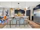 Stylish kitchen boasts dark cabinets, granite countertops, and island seating with pendant lighting at 8256 Bayview Crossing Dr, Winter Garden, FL 34787