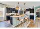 Beautiful kitchen with dark cabinets, granite countertops, and island seating, creating a functional space at 8256 Bayview Crossing Dr, Winter Garden, FL 34787