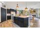 Open-concept kitchen with granite island and seamless flow into a modern living space at 8256 Bayview Crossing Dr, Winter Garden, FL 34787