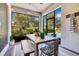 Charming screened lanai with a wooden table, bench, string lights, and peaceful outdoor view at 8256 Bayview Crossing Dr, Winter Garden, FL 34787