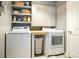 Laundry room with a front-loading washer and dryer, a countertop, and storage shelves at 8256 Bayview Crossing Dr, Winter Garden, FL 34787