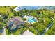 Aerial view of a large pool and clubhouse, surrounded by lush landscaping, sand volleyball, and other amenities at 8256 Bayview Crossing Dr, Winter Garden, FL 34787