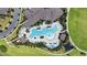 Aerial view of a large community pool with palm trees, lounge chairs, and a nearby playground at 8256 Bayview Crossing Dr, Winter Garden, FL 34787