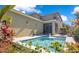 Relaxing pool view featuring a water fountain, vibrant plants, and a screened lanai at 8256 Bayview Crossing Dr, Winter Garden, FL 34787