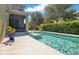 Backyard pool featuring water fountain feature with a screened-in lanai and green landscaping at 8256 Bayview Crossing Dr, Winter Garden, FL 34787