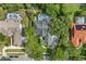 Aerial view of gray house featuring mature trees, screened-in lanai, long drive, and lush landscaping at 8612 Summerville Pl, Orlando, FL 32819