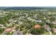 Aerial view of houses surrounded by lots of green trees and the cityscape in the background at 8612 Summerville Pl, Orlando, FL 32819