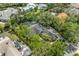 Aerial view of home with mature trees, screened-in lanai, long drive, and lush landscaping at 8612 Summerville Pl, Orlando, FL 32819