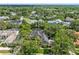 An aerial view of the home and neighborhood surrounded by mature landscaping and trees at 8612 Summerville Pl, Orlando, FL 32819