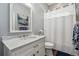 Bathroom with white marble-top vanity and a shower with glass door at 8612 Summerville Pl, Orlando, FL 32819
