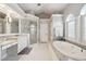 Spacious primary bathroom with soaking tub, glass shower, and double vanity at 8612 Summerville Pl, Orlando, FL 32819