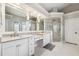 Bright bathroom features double sinks, granite counters, and a glass-enclosed shower at 8612 Summerville Pl, Orlando, FL 32819