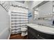 Bathroom with marble vanity, framed mirror, and striped shower curtain at 8612 Summerville Pl, Orlando, FL 32819