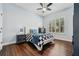 Cozy bedroom with a ceiling fan, a checkered bedspread, and bright window at 8612 Summerville Pl, Orlando, FL 32819