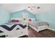 Shared bedroom featuring wood floors, ceiling fan, and two beds with storage drawers at 8612 Summerville Pl, Orlando, FL 32819