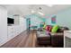 Bright bonus room with a large couch, a built-in cabinet, and a ceiling fan at 8612 Summerville Pl, Orlando, FL 32819