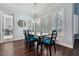 Dining room features a wood table, dark chairs with blue cushions, and large windows at 8612 Summerville Pl, Orlando, FL 32819
