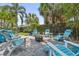 Outdoor seating area with firepit and Adirondack chairs, surrounded by lush landscaping at 8612 Summerville Pl, Orlando, FL 32819