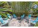 Outdoor firepit area surrounded by mature bamboo and relaxing Adirondack chairs at 8612 Summerville Pl, Orlando, FL 32819