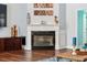 Beautiful fireplace with decorative mantel, hardwood floors, and a flat screen TV in a bright living room at 8612 Summerville Pl, Orlando, FL 32819