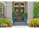 Elegant double front doors adorned with wreaths, complemented by vibrant potted plants at 8612 Summerville Pl, Orlando, FL 32819