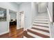 Hallway features stairs, wood floors, white trim and doors leading to other rooms at 8612 Summerville Pl, Orlando, FL 32819