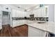 Eat-in kitchen boasts stainless appliances, white cabinetry, and granite countertops at 8612 Summerville Pl, Orlando, FL 32819