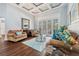 Comfortable living room featuring hardwood floors, coffered ceilings, and french doors at 8612 Summerville Pl, Orlando, FL 32819
