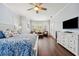 Bright and airy main bedroom with plantation shutters, wood floors, and comfortable sitting area at 8612 Summerville Pl, Orlando, FL 32819