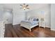Bright main bedroom features wood floors and large windows with plantation shutters at 8612 Summerville Pl, Orlando, FL 32819