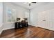 Bright office space with dark wood floors, dual workstations, plantation shutters, and ample storage at 8612 Summerville Pl, Orlando, FL 32819