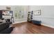 Bright office space featuring wood floors, large window with plantation shutters, and a built-in bookcase at 8612 Summerville Pl, Orlando, FL 32819