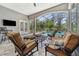 Relaxing screened patio features comfortable seating and a view of the pool at 8612 Summerville Pl, Orlando, FL 32819