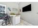Patio bar area with a sink, granite countertops, and outdoor seating at 8612 Summerville Pl, Orlando, FL 32819