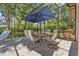 Outdoor dining area on the screened-in lanai with an umbrella table set at 8612 Summerville Pl, Orlando, FL 32819