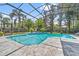 A relaxing screened-in pool area with tropical landscaping and tiled deck at 8612 Summerville Pl, Orlando, FL 32819