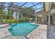 Beautiful screened-in pool area with tiled deck and chairs for relaxing by the pool at 8612 Summerville Pl, Orlando, FL 32819