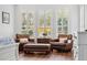 Comfortable bedroom sitting area with wood floors, natural light and leather chairs at 8612 Summerville Pl, Orlando, FL 32819
