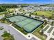 Aerial view features tennis courts and other recreational areas in a community setting at 6231 Atkinson Ln, The Villages, FL 32163