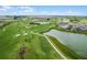 Aerial view of the community golf course, ponds and neighborhood on a partly sunny day at 6231 Atkinson Ln, The Villages, FL 32163