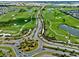 Vibrant aerial showcases a scenic community, lush golf course, and beautiful landscaping at 6231 Atkinson Ln, The Villages, FL 32163