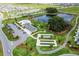 Aerial view of community clubhouse, pool, shuffleboard, ponds, and parking surrounded by well-maintained lawns at 6231 Atkinson Ln, The Villages, FL 32163
