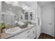 Bright bathroom featuring double sinks with granite countertop, decorative backsplash, and a glass door shower at 6231 Atkinson Ln, The Villages, FL 32163