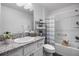 Well-lit bathroom featuring single sink vanity with granite countertop, shower and tub combo at 6231 Atkinson Ln, The Villages, FL 32163