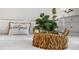 Detailed view of the bedroom showcasing a decorative basket on the bed and a bedside table setup at 6231 Atkinson Ln, The Villages, FL 32163