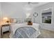 Comfortable bedroom featuring a ceiling fan, side tables, window, and tasteful decor at 6231 Atkinson Ln, The Villages, FL 32163